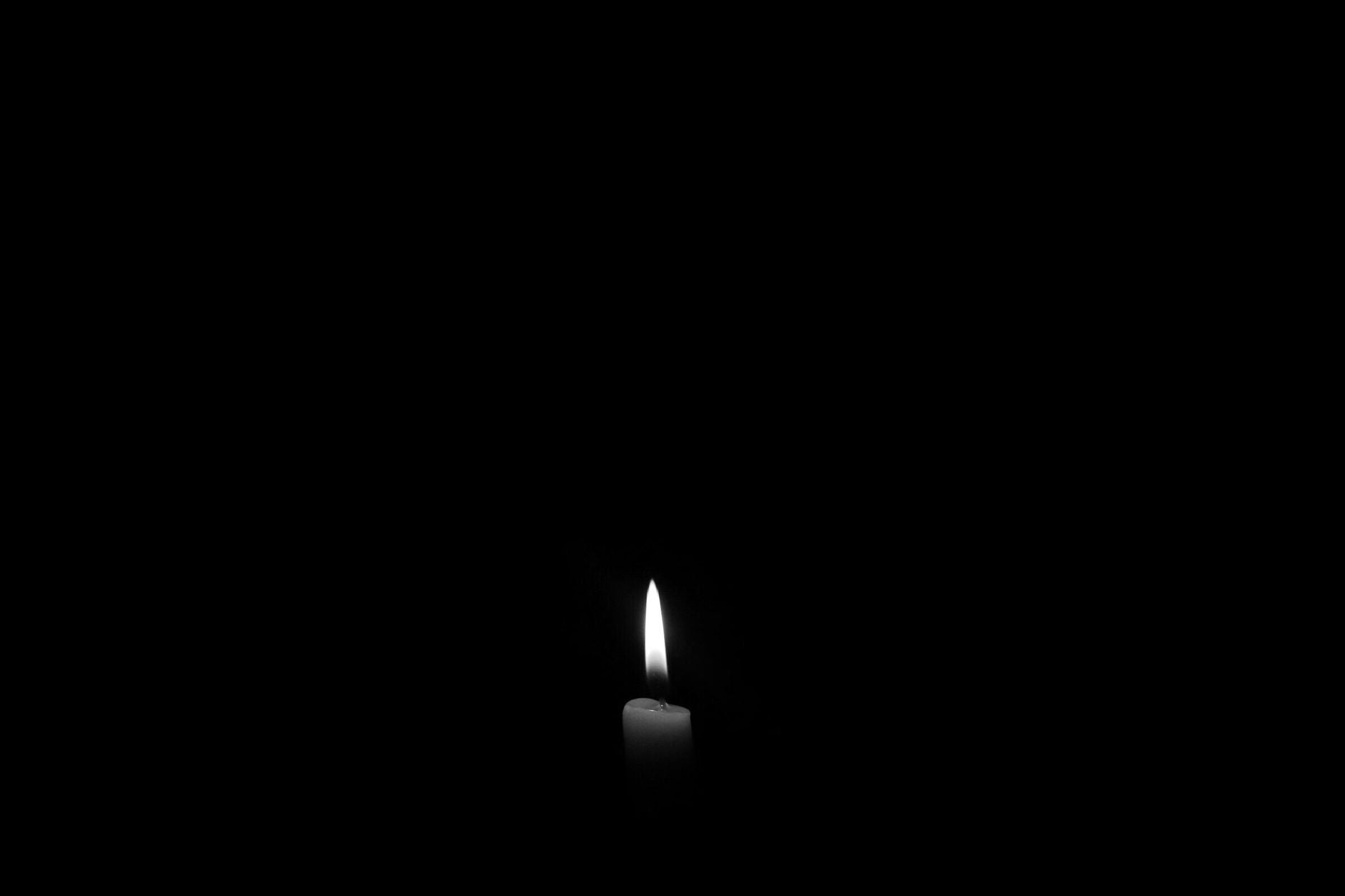 Single candle flame burning steadily — symbol of consistent daily practice