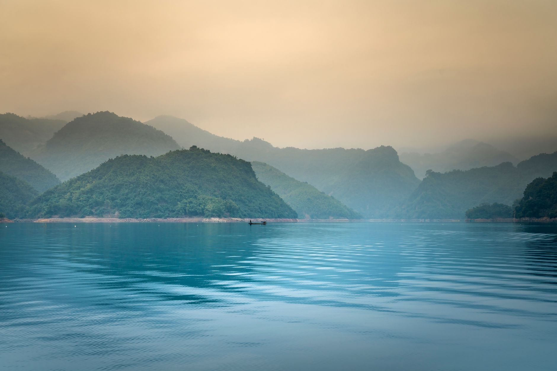 Calm sea at dawn under soft mist — the apparent flatness of a plateau in consciousness work