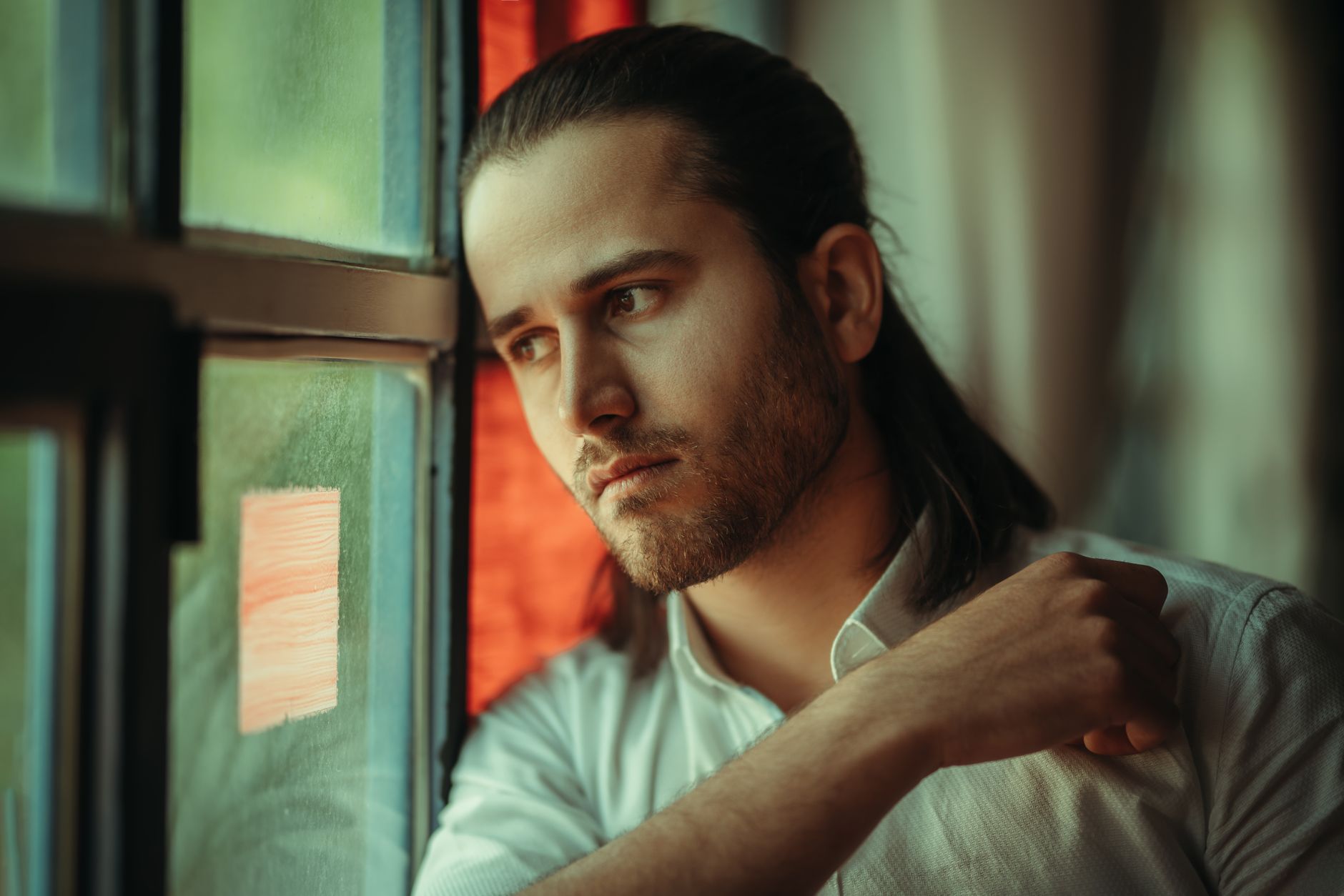 Contemplative person at window - consciousness as the prerequisite
