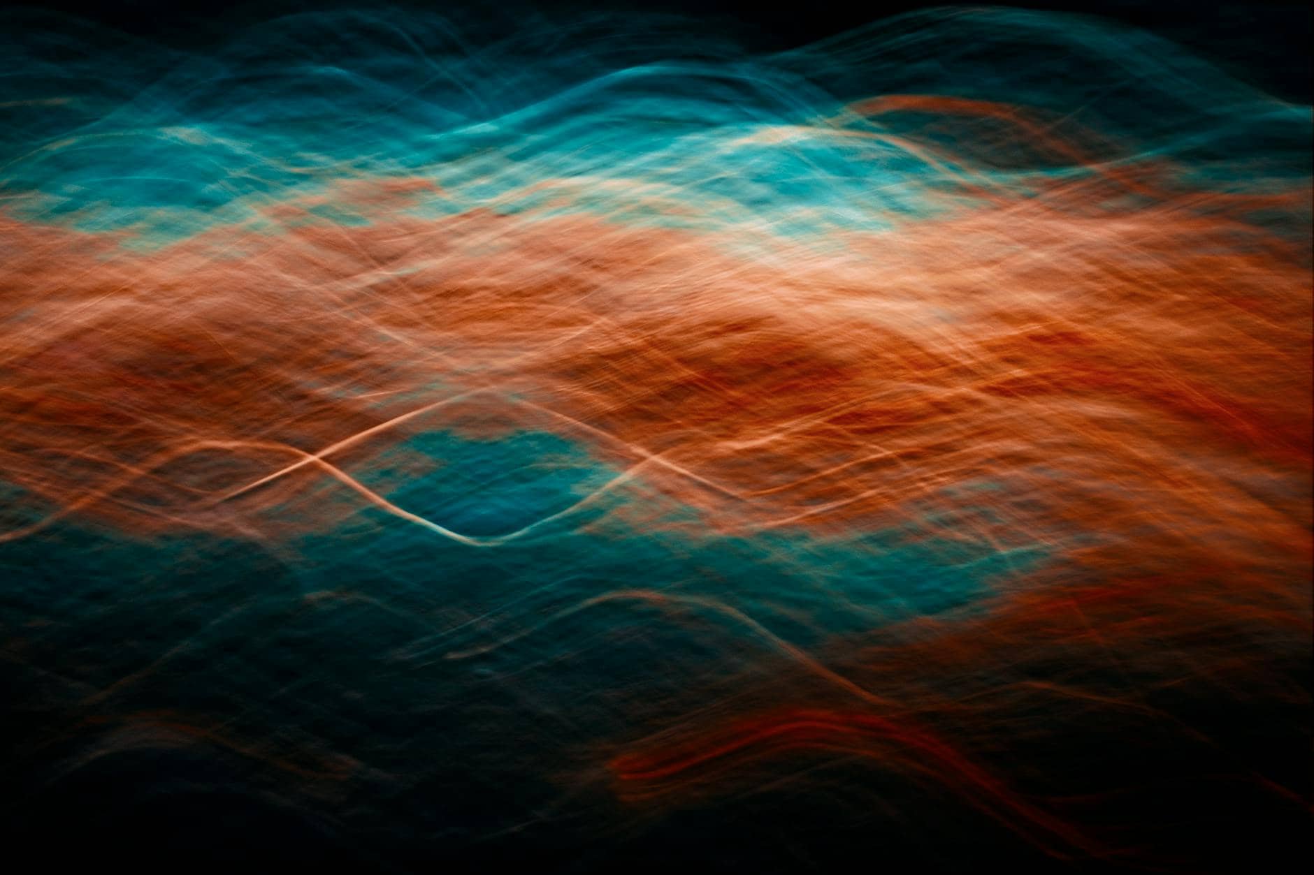 Abstract waves of orange and blue light in motion, illustrating the principle that nothing rests