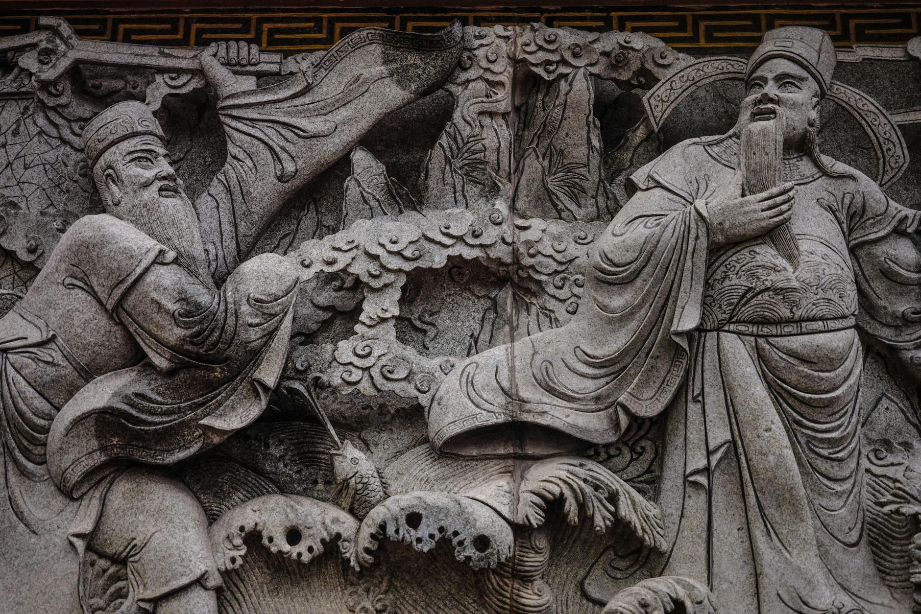 Intricate stone carving of ancient figures, the mythic record of the Anunnaki