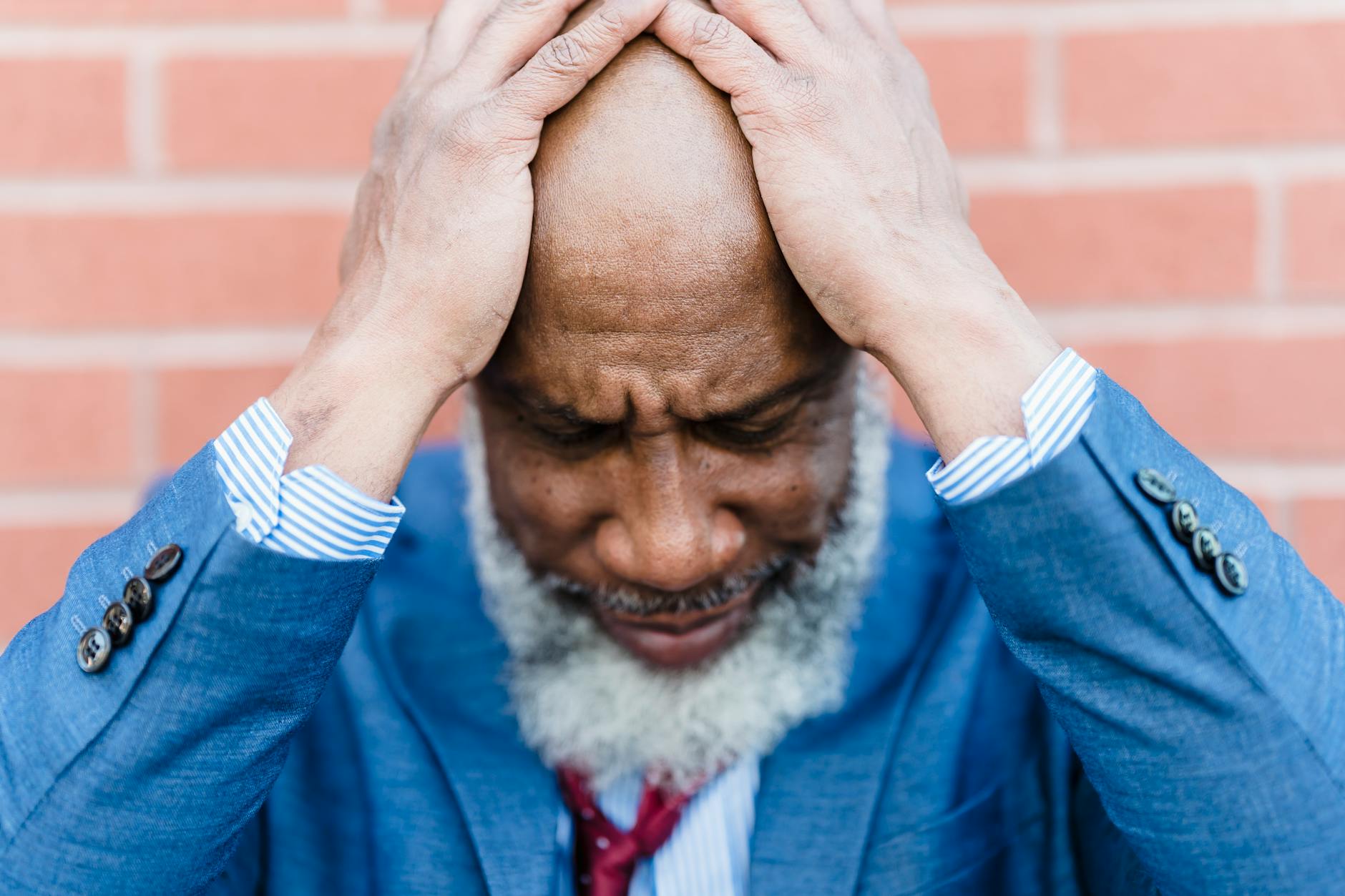 A person with their head in their hands, the strain of cross-domain collapse