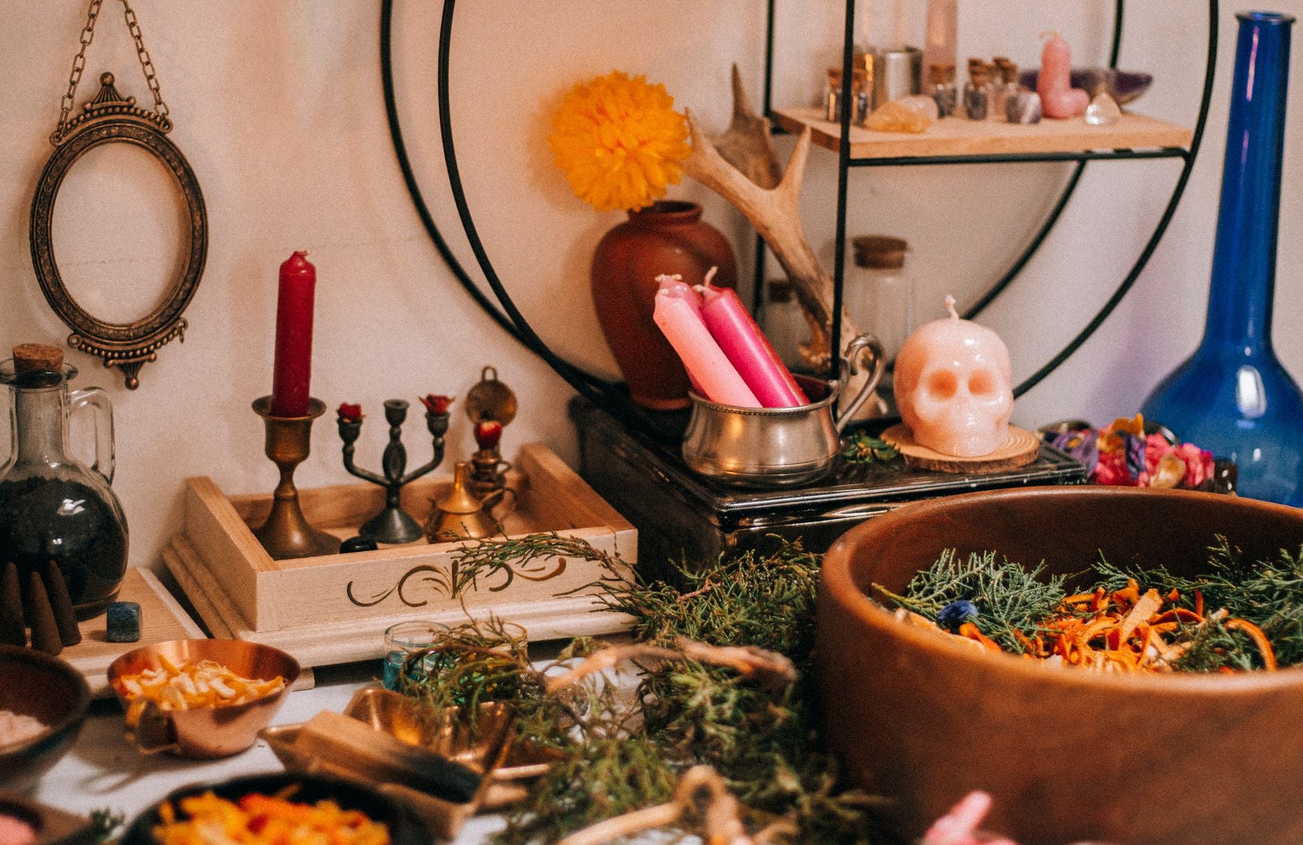 A small home altar of magical herbs and ritual artifacts arranged for consecration, photographed in warm natural light