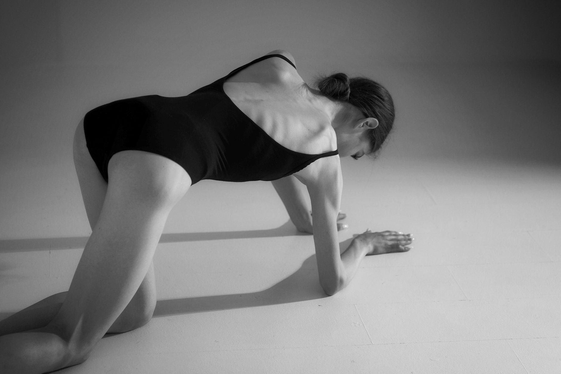 Posture and Inner State — a practitioner sitting in an upright axial meditation posture, spine stacked, chest open, head balanced over the column