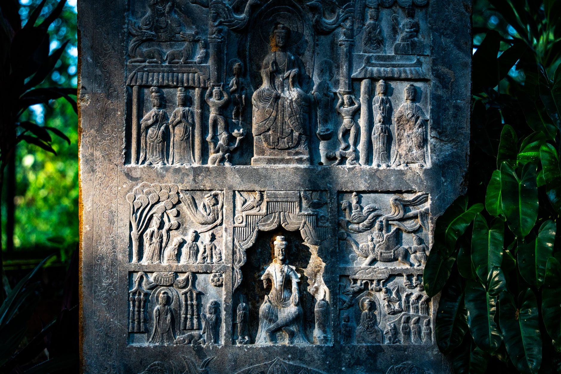 Detailed close-up of an ornate ancient stone carving showing layered symbols, illustrating the long lineage of consecration practice