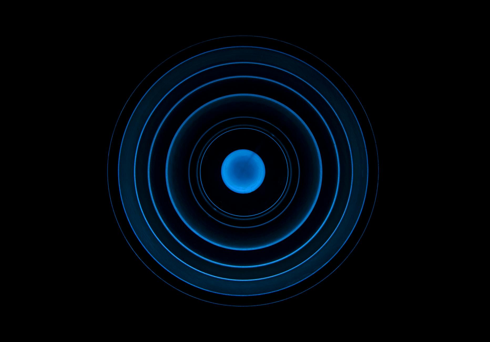 A spiral staircase rising in repeating turns, illustrating vibration moving upward by octaves