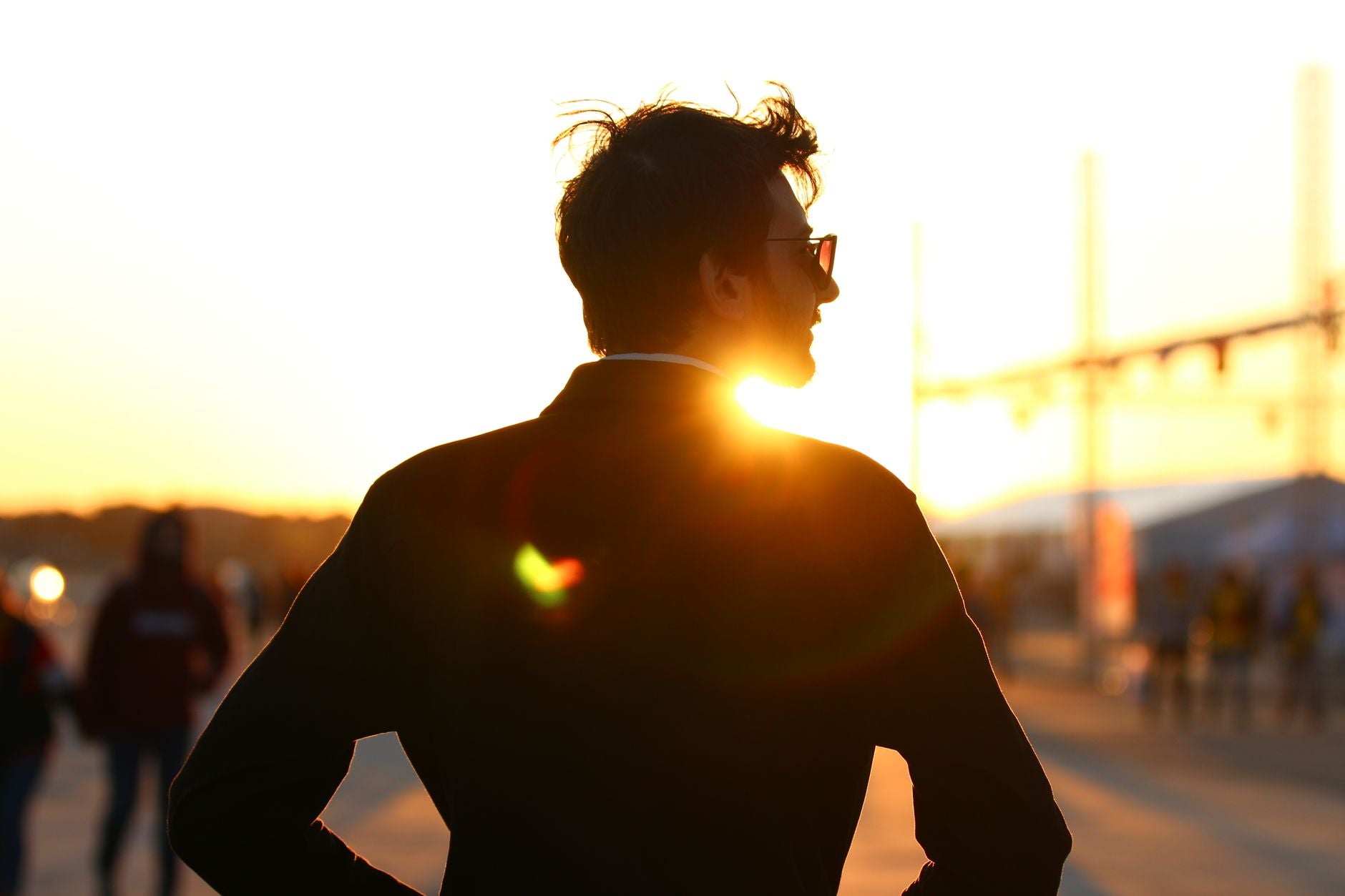 Silhouette of a person facing the sun at golden hour, the orienting phase of solar practice